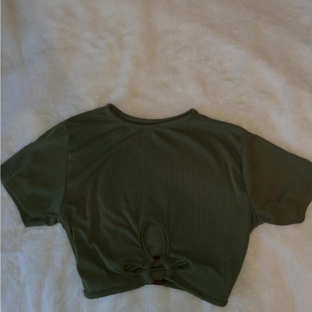 green top with design and ring